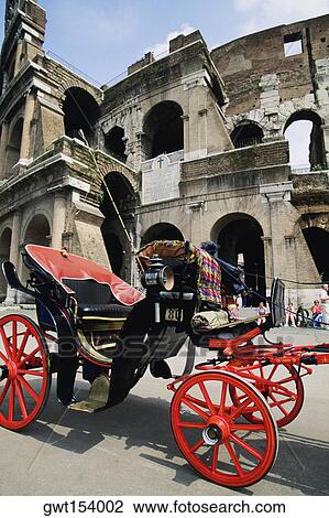 Stock Image - Horse drawn carriage in front of a colosseum, Rome, Italy. Fotosearch