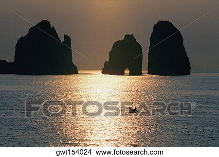 Silhouette of cliffs in the sea during sunrise, Capri, Italy View Large Photo Image Picture - Silhouette of cliffs in the sea during sunrise, Capri, Italy. Fotosearch