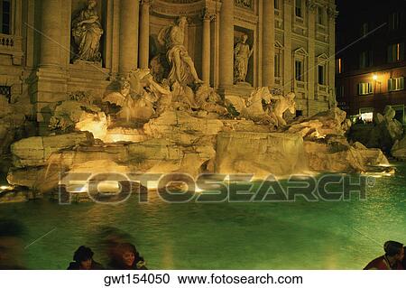 Statues at a fountain lit up at night, Trevi Fountain, Rome, Italy View Large Photo Image Stock Image - Statues at a fountain lit up at night, Trevi Fountain, Rome, Italy. Fotosearch