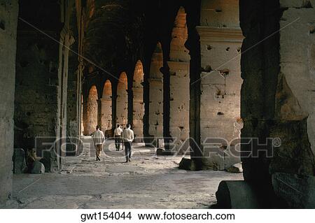 Tourists walking inside a coliseum, Rome, Italy View Large Photo Image Picture - Tourists walking inside a coliseum, Rome, Italy. Fotosearch