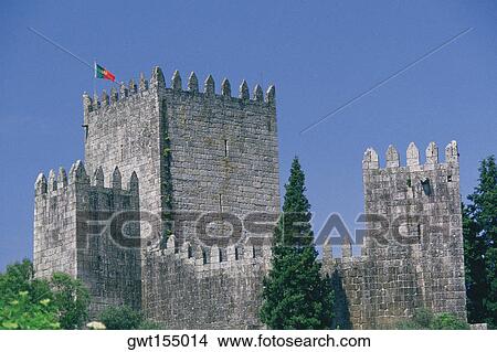Picture - Flag on the top of a castle, Dukes of Braganca Palace, Guimaraes, Minho, Portugal. Fotosearch