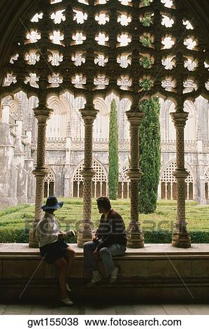 Side profile of two people sitting in the courtyard of a church, Portugal View Large Photo Image Stock Photo - Side profile of two people sitting in the courtyard of a church, Portugal. Fotosearch