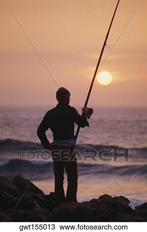Silhouette of a fishermen holding a fishing rod, Portugal View Large Photo Image Stock Image - Silhouette of a fishermen holding a fishing rod, Portugal. Fotosearch