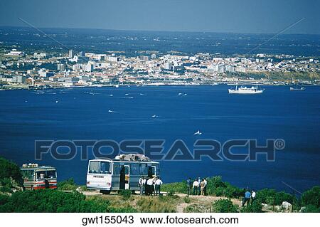 Stock Image - Tourists near a bus, Setubal, Portugal. Fotosearch