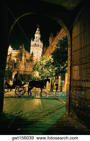 Low angle view of a tower tit up at night, Seville, Spain View Large Photo Image Stock Photo - Low angle view of a tower tit up at night, Seville, Spain. Fotosearch