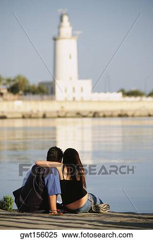 Man and woman sitting near water, Malaga, Spain View Large Photo Image Stock Photography - Man and woman sitting near water, Malaga, Spain. Fotosearch