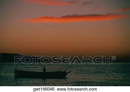 Silhouette of a fisherman on a fishing boat, Malaga, Spain View Large Photo Image Stock Photograph - Silhouette of a fisherman on a fishing boat, Malaga, Spain. Fotosearch