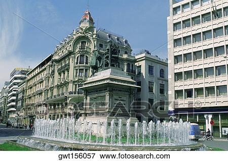 Stock Photo - Statue and a fountain in front of buildings, Granada, Andalusia, Spain. Fotosearch