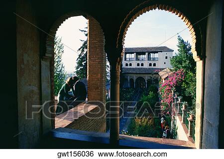Stock Photograph - Tourist in a palace, Alhambra, Granada, Andalusia, Spain. Fotosearch