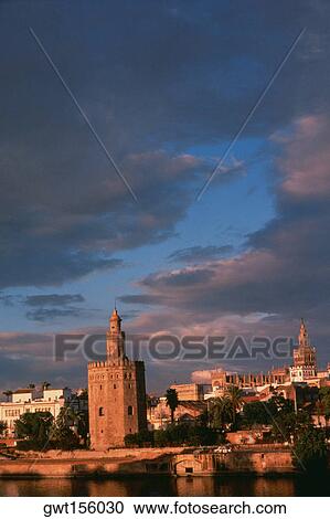 Stock Image - Towers in a city, Gold Tower, La Giralda, Seville, Spain. Fotosearch