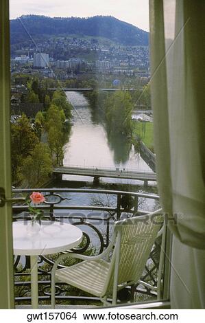 Picture - High angle view of a chair and a table in a balcony, Hotel Bellevue Palace, Berne, Berne Canton, Switzerland. Fotosearch