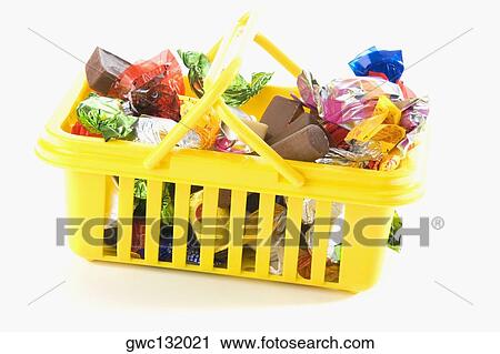 Close-up of chocolates and gifts in a basket View Large Photo Image Stock Image - Close-up of chocolates and gifts in a basket. Fotosearch