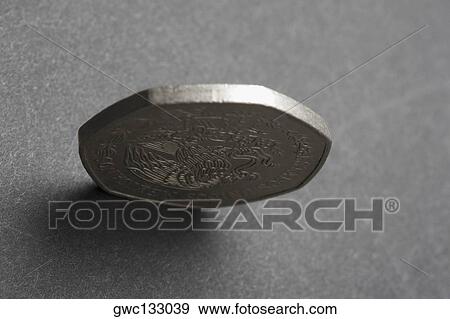 Close-up of a coin standing View Large Photo Image Stock Photo - Close-up of a coin standing. Fotosearch
