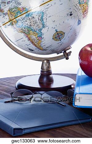 Close-up of a globe and a file on the table View Large Photo Image Stock Image - Close-up of a globe and a file on the table. Fotosearch