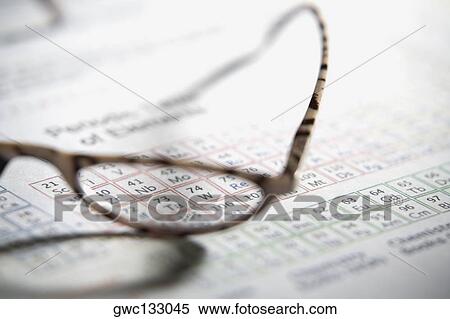 Stock Photography - Close-up of a pair of eyeglass on a periodic table. Fotosearch