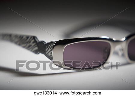 Close-up of a pair of sunglasses View Large Photo Image Picture - Close-up of a pair of sunglasses. Fotosearch