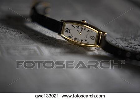 Close-up of a wristwatch on a newspaper View Large Photo Image Stock Image - Close-up of a wristwatch on a newspaper. Fotosearch