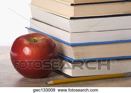 Close-up of an apple near a stack of books View Large Photo Image Stock Photo - Close-up of an apple near a stack of books. Fotosearch