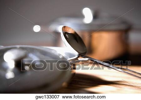 Close-up of bowls with lids and a ladle on a table View Large Photo Image Stock Photo - Close-up of bowls with lids and a ladle on a table. Fotosearch