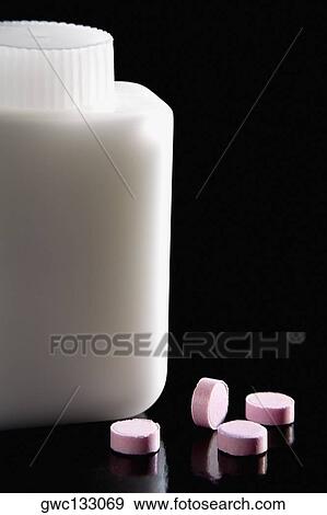 Close-up of four pills near a pill bottle View Large Photo Image Stock Photo - Close-up of four pills near a pill bottle. Fotosearch