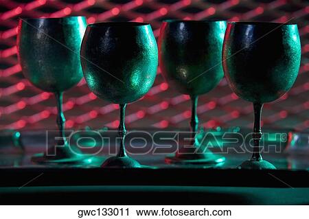 Close-up of four wine goblets in a row View Large Photo Image Stock Image - Close-up of four wine goblets in a row. Fotosearch