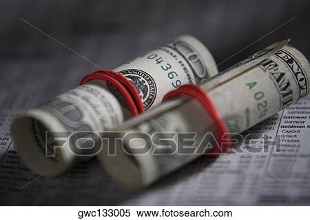Stock Photography - Close-up of paper currency rolls with rubber bands. Fotosearch