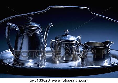 Stock Image - Close-up of tea kettles on a serving tray. Fotosearch