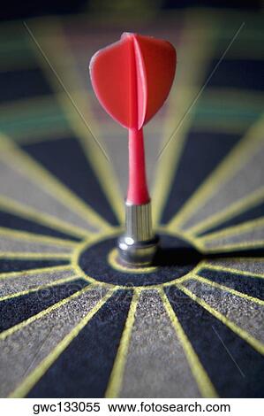 Dart in the bull's-eye of a dartboard View Large Photo Image Stock Photography - Dart in the bull's-eye of a dartboard. Fotosearch