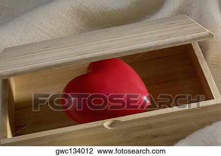 Stock Image - Close-up of a heart in a wooden box. Fotosearch