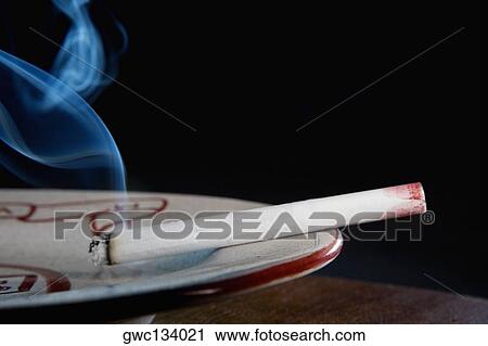 Close-up of a lipstick mark on a cigarette in an ashtray View Large Photo Image Stock Image - Close-up of a lipstick mark on a cigarette in an ashtray. Fotosearch
