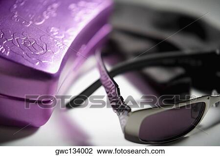 Stock Image - Close-up of a pair of sunglasses with a box. Fotosearch