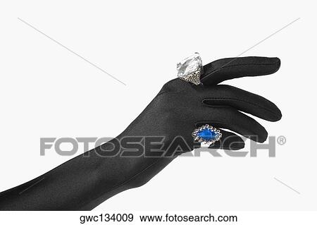 Stock Photo - Close-up of a person's hand with two rings. Fotosearch