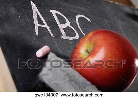 Close-up of an apple and a duster on a blackboard View Large Photo Image Stock Photo - Close-up of an apple and a duster on a blackboard. Fotosearch