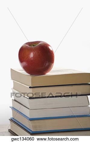 Stock Image - Close-up of an apple on a stack of books. Fotosearch