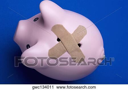 High angle view of adhesive bandages covering the slot of a piggy bank View Large Photo Image Stock Image - High angle view of adhesive bandages covering the slot of a piggy bank. Fotosearch