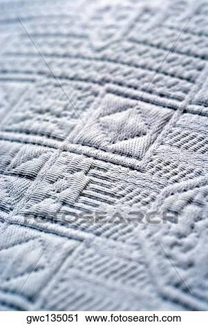 Stock Image - Close-up of an embossed design on fabric. Fotosearch