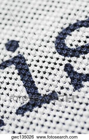 Close-up of letters on a woolen fabric View Large Photo Image Stock Photograph - Close-up of letters on a woolen fabric. Fotosearch