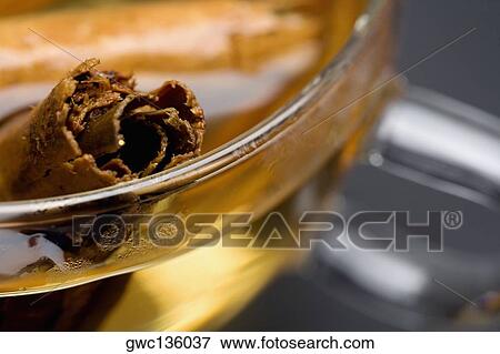 Close-up of a cinnamon stick in a bowl of cider View Large Photo Image Stock Photo - Close-up of a cinnamon stick in a bowl of cider. Fotosearch