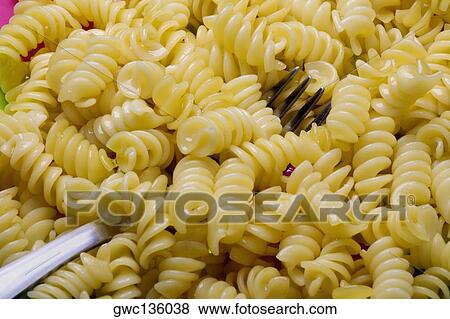 Close-up of a fork in fusilli View Large Photo Image Stock Photo - Close-up of a fork in fusilli. Fotosearch