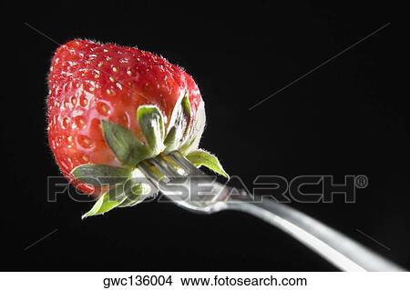 Close-up of a fork with a strawberry View Large Photo Image Picture - Close-up of a fork with a strawberry. Fotosearch