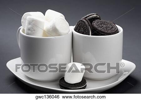 Close-up of cookies and marshmallows in two cup View Large Photo Image Stock Photograph - Close-up of cookies and marshmallows in two cup. Fotosearch