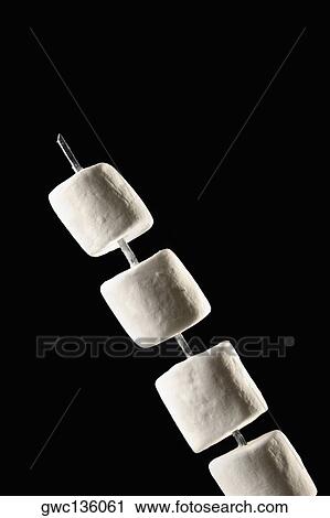 Close-up of marshmallows on a skewer View Large Photo Image Stock Image - Close-up of marshmallows on a skewer. Fotosearch