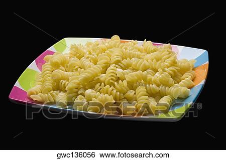Close-up of pasta in a tray View Large Photo Image Stock Photograph - Close-up of pasta in a tray. Fotosearch