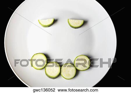 Close-up of slices of zucchini in a plate making a smiling face View Large Photo Image Stock Image - Close-up of slices of zucchini in a plate making a smiling face. Fotosearch