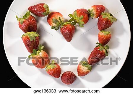 Close-up of strawberries in a plate in the shape of a heart View Large Photo Image Stock Image - Close-up of strawberries in a plate in the shape of a heart. Fotosearch