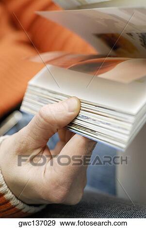 Close-up of a person's hand holding a book View Large Photo Image Stock Photo - Close-up of a person's hand holding a book. Fotosearch