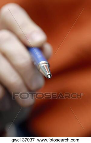 Close-up of a person's hand holding a ballpoint pen View Large Photo Image Stock Photo - Close-up of a person's hand holding a ballpoint pen. Fotosearch