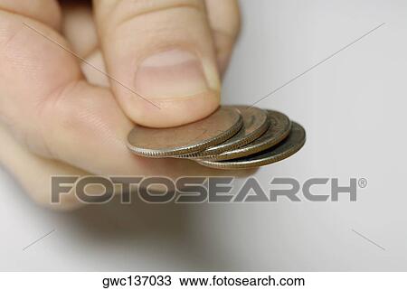 Close-up of a person's hand holding four coins View Large Photo Image Stock Image - Close-up of a person's hand holding four coins. Fotosearch