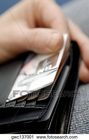 Close-up of a person's hand taking a credit card out of a wallet View Large Photo Image Stock Image - Close-up of a person's hand taking a credit card out of a wallet. Fotosearch