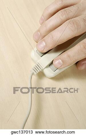 Stock Image - Close-up of a person's hand using a computer mouse. Fotosearch